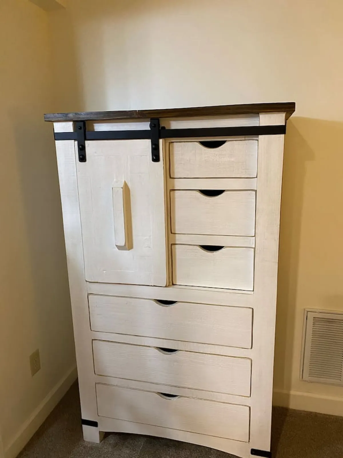 This image features a stylish dresser positioned near a sliding door, with details such as sleek drawer handles and a smooth surface ready for decorative touches. The space has a warm, inviting feel, hinting at an entryway or transitional area where organization and personalization are key.